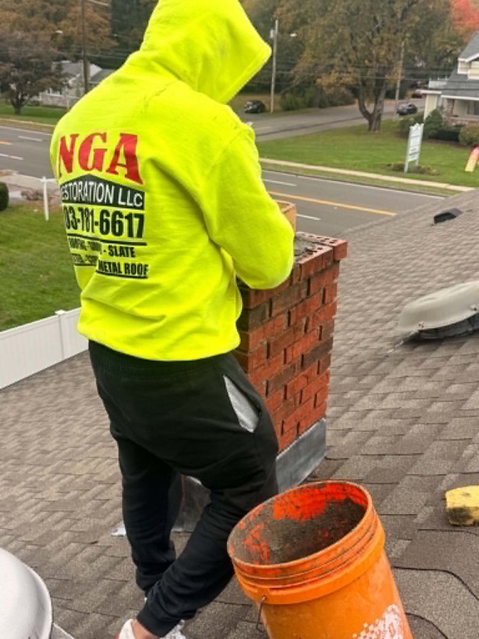Work in progress: NGA crew member preparing the chimney for a new cap - Hamden, CT