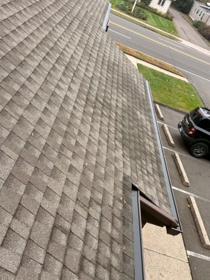 Gutter guard installation along the sloping roof edge - Hamden, CT