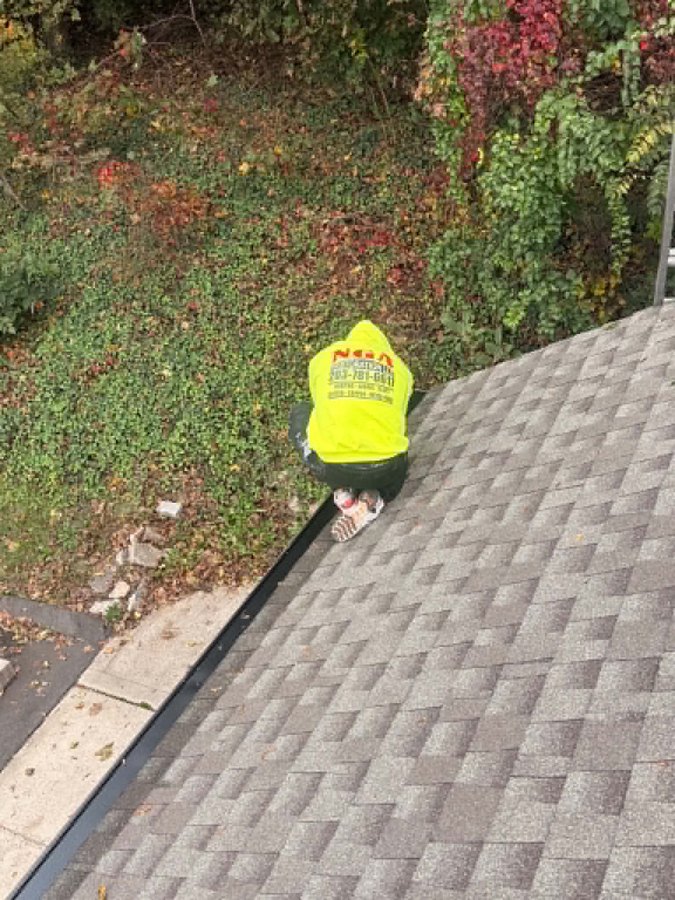 NGA crew member installing gutter guards at the roof edge - Hamden, CT